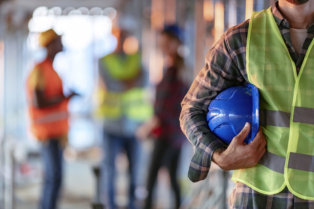 Man holding blue safety hat